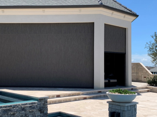 Motorized hurricane shutters for windows on a Florida patio, modern exterior storm protection solution