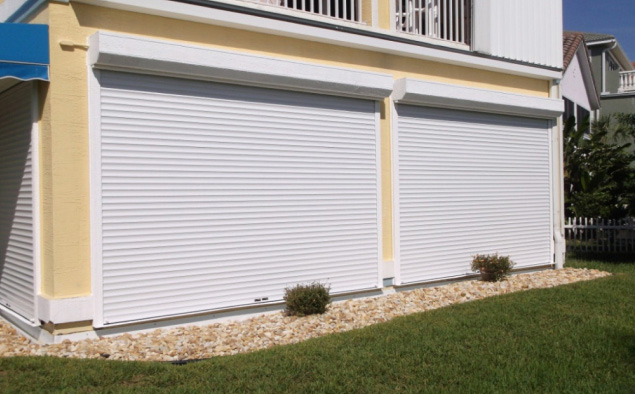 White roll-down hurricane shutters for windows on a Florida home, exterior storm protection solution